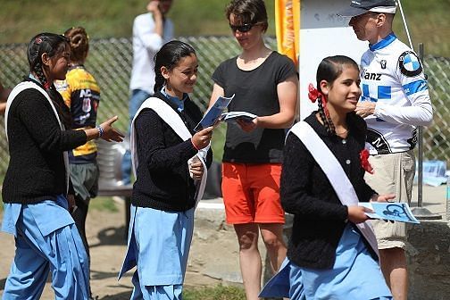 Monika Eggert, wife of Thomas Eggert, a German rider at Hero MTB Himalaya 12th Edition, distributing notebooks to the kids as a part of Mission SMILE, the social outreach program of HASTPA- Himalayan Adventure Sports and Tourism Association.